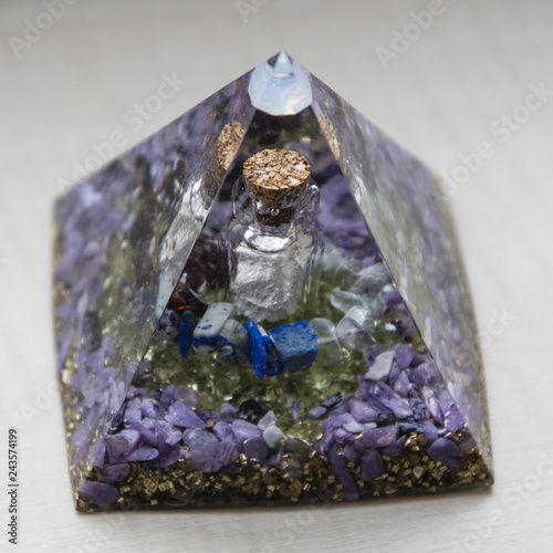 Orgonite - pyramid with a vial and stones inside.