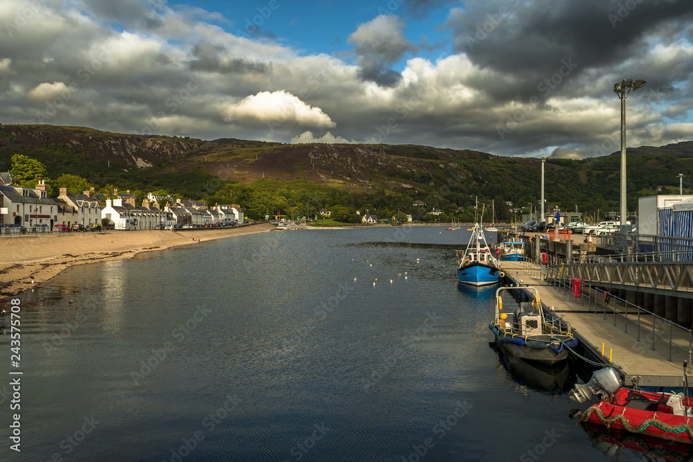 City Of Ullapool With Old Fishing Boat At Loch Broom In Scotland
