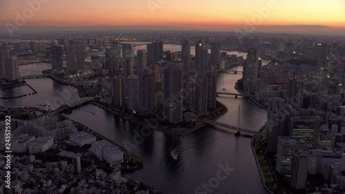 Tokyo, Japan circa-2018.  Flying over Sumida River and Tokyo Bay at dusk.  Shot from helicopter with RED camera. photo