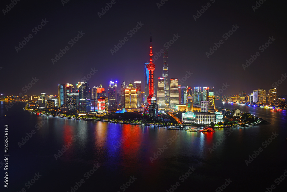 A night view of the modern Pudong skyline across the Bund in Shanghai, China A night view of the modern Pudong skyline across the Bund in Shanghai, China