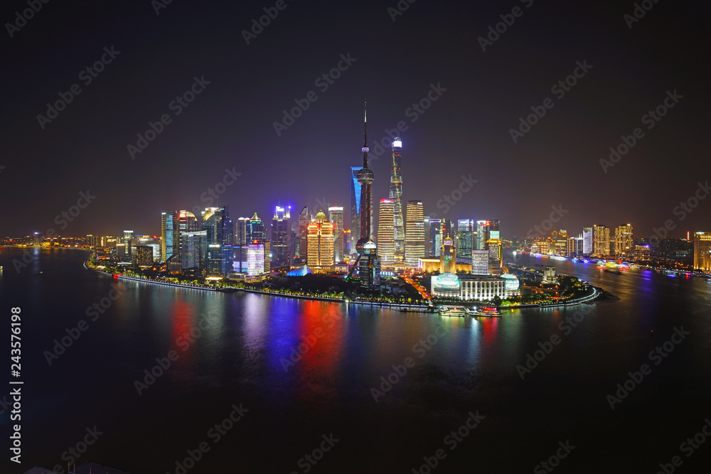 A night view of the modern Pudong skyline across the Bund in Shanghai, China A night view of the modern Pudong skyline across the Bund in Shanghai, China