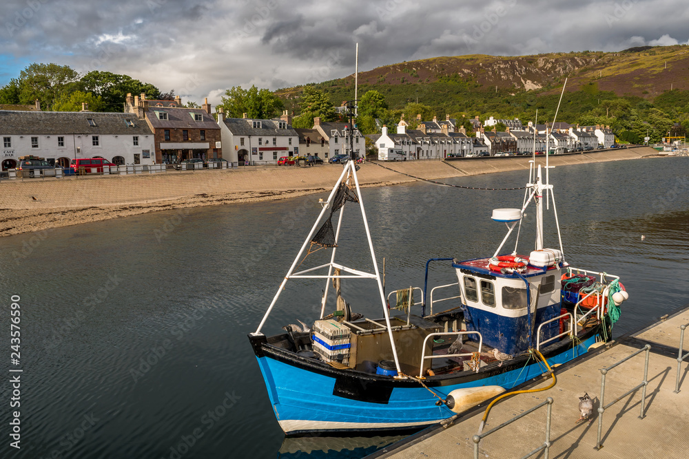 City Of Ullapool With Old Fishing Boat At Loch Broom In Scotland