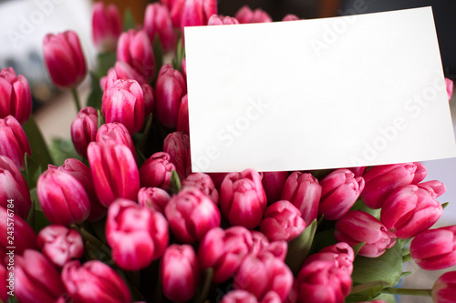 Bouquet of pink tulips with a note. photo