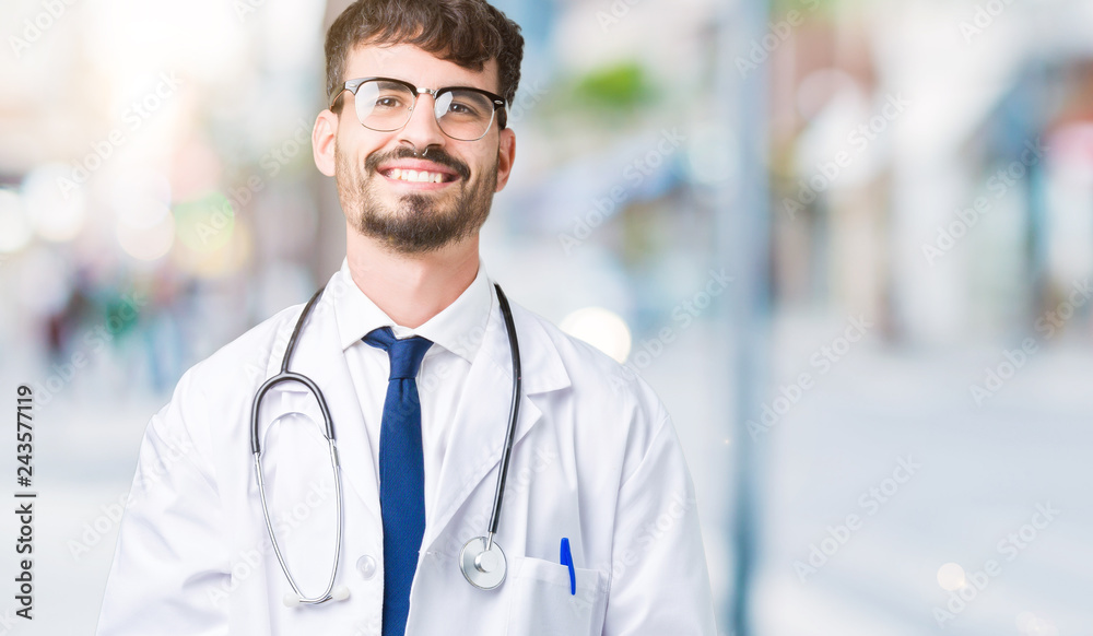 Young doctor man wearing hospital coat over isolated background Hands together and fingers crossed smiling relaxed and cheerful. Success and optimistic Young doctor man wearing hospital coat over isolated background Hands together and fingers crossed smiling relaxed and cheerful. Success and optimistic