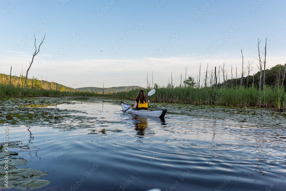 white kayak with woman paddling white kayak with woman paddling