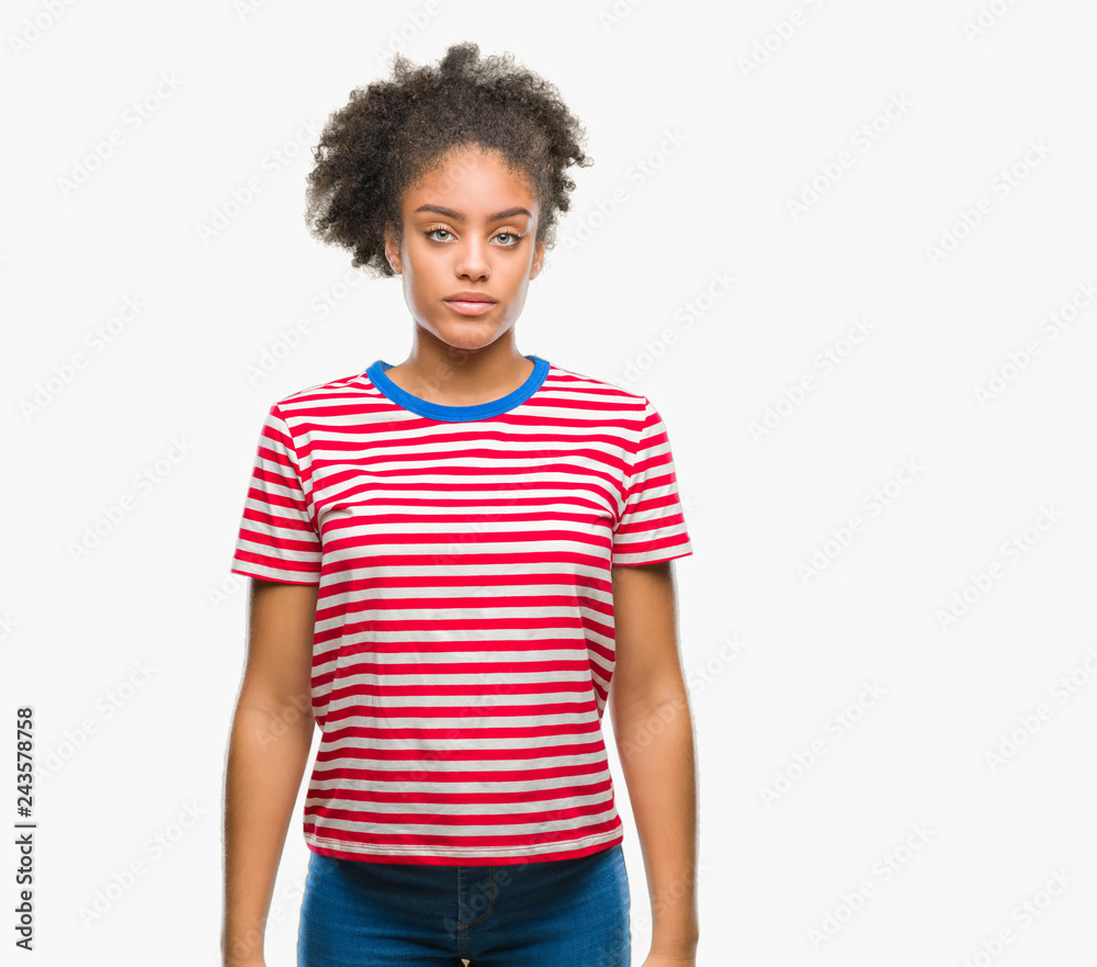 Young afro american woman over isolated background with serious expression on face. Simple and natural looking at the camera. Young afro american woman over isolated background with serious expression on face. Simple and natural looking at the camera.