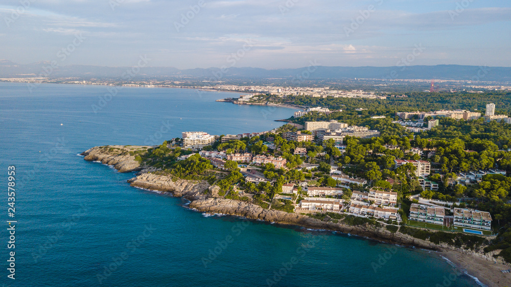 Salou beach in summer, Costa Daurada coastline in the sunrise. Travel destination in Spain for holidays. Aerial view of the rocks and the Mediterranean sea