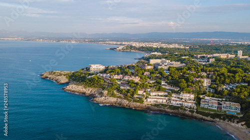 Salou beach in summer, Costa Daurada coastline in the sunrise. Travel destination in Spain for holidays. Aerial view of the rocks and the Mediterranean sea