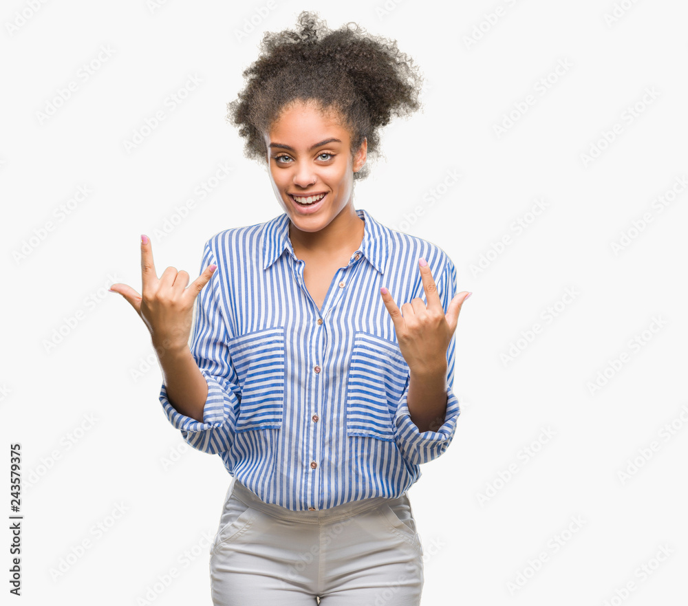 Young afro american woman over isolated background shouting with crazy expression doing rock symbol with hands up. Music star. Heavy concept. Young afro american woman over isolated background shouting with crazy expression doing rock symbol with hands up. Music star. Heavy concept.