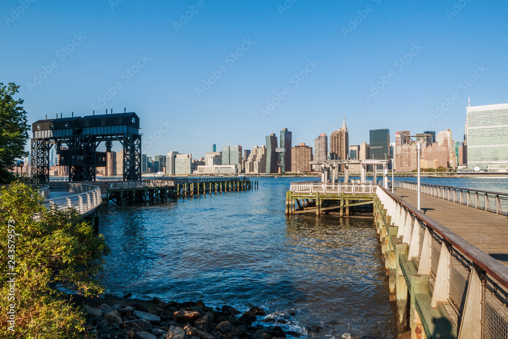Pier in New York City - USA. Manhattan downtown skyline in the morning al view of New York City - USA. Manhattan downtown skyline and skyscrapers. Pier in New York City - USA. Manhattan downtown skyline in the morning al view of New York City - USA. Manhattan downtown skyline and skyscrapers.