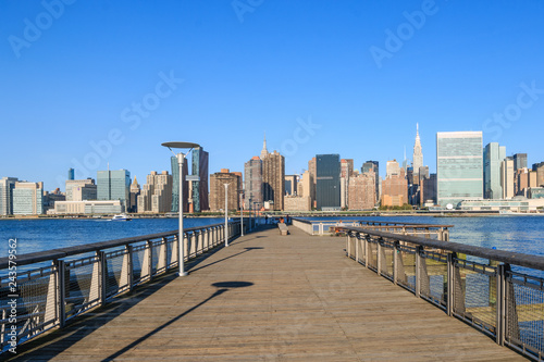 Pier in New York City - USA. Manhattan downtown skyline in the morning al view of New York City - USA. Manhattan downtown skyline and skyscrapers. © Xavier Lorenzo