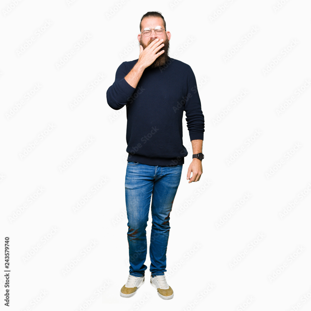 Young blond man wearing glasses and turtleneck sweater bored yawning tired covering mouth with hand. Restless and sleepiness. Young blond man wearing glasses and turtleneck sweater bored yawning tired covering mouth with hand. Restless and sleepiness.