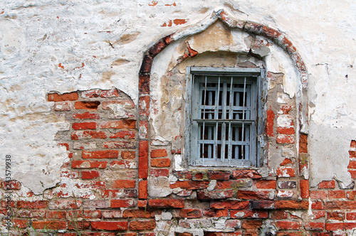 Shabby wall and window of an old othodox church photo