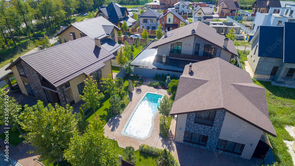 house in suburb with pool from drone
