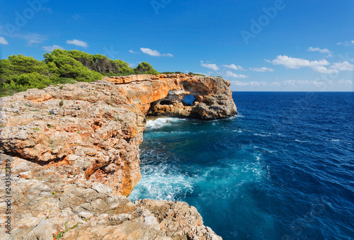 View on rocks with hole and deep blue sea.Mallorca Island, Spain photo