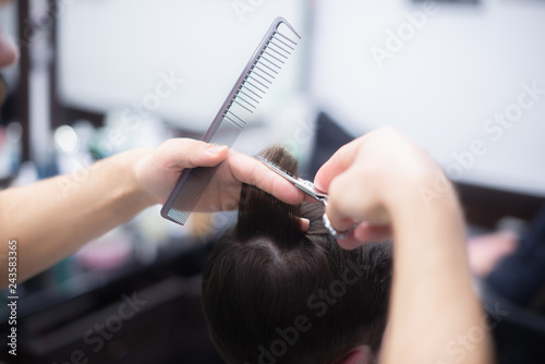 Professional hairstyle in barbershop. Men's hair care.