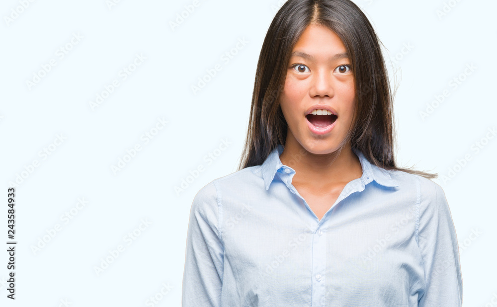 Young asian business woman over isolated background afraid and shocked with surprise expression, fear and excited face. Young asian business woman over isolated background afraid and shocked with surprise expression, fear and excited face.