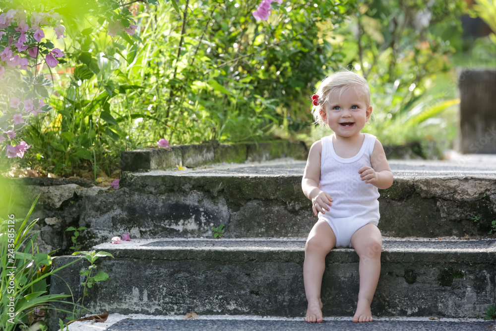 Outdoor portrait of a cute baby girl sitting on the stairs Outdoor portrait of a cute baby girl sitting on the stairs
