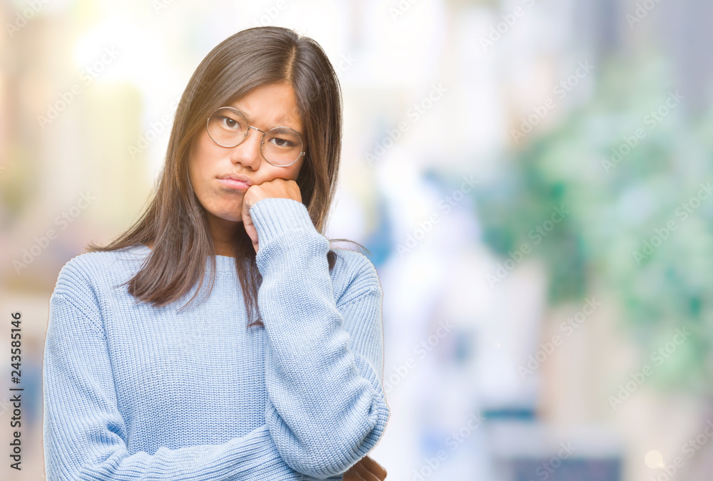 Young asian woman wearing winter sweater over isolated background thinking looking tired and bored with depression problems with crossed arms.