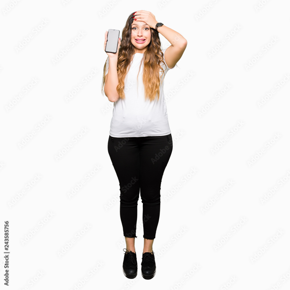 Young adult woman showing smartphone screen stressed with hand on head, shocked with shame and surprise face, angry and frustrated. Fear and upset for mistake. Young adult woman showing smartphone screen stressed with hand on head, shocked with shame and surprise face, angry and frustrated. Fear and upset for mistake.
