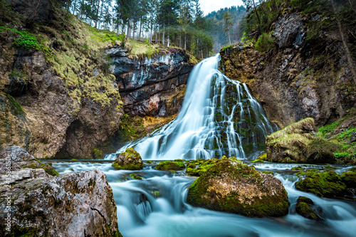 Fototapeta Naklejka Na Ścianę i Meble -  Idyllic waterfall scene with mossy rocks in the forest