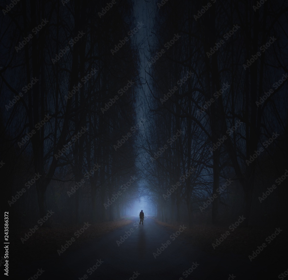 Surreal horror scene with alone strange man in dark night forest ...