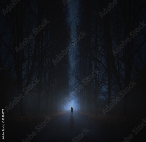 Surreal horror scene with alone strange man in dark night forest