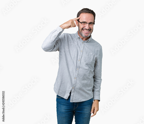 Handsome middle age elegant senior man wearing glasses over isolated background Smiling pointing to head with one finger, great idea or thought, good memory