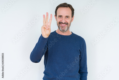 Elegant senior man over isolated background showing and pointing up with fingers number three while smiling confident and happy.
