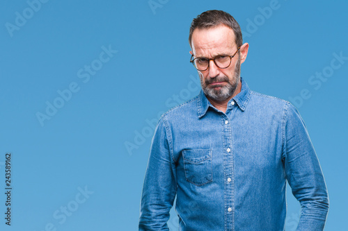 Middle age hoary senior man wearing glasses over isolated background skeptic and nervous, frowning upset because of problem. Negative person.