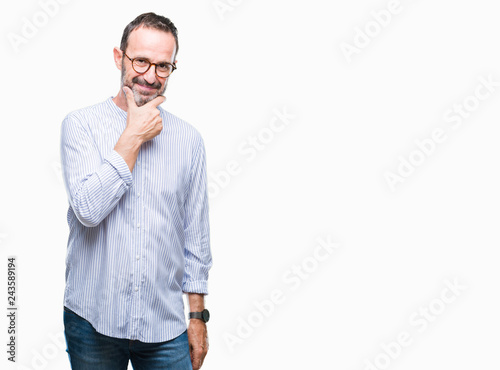 Middle age hoary senior man wearing glasses over isolated background looking confident at the camera with smile with crossed arms and hand raised on chin. Thinking positive.