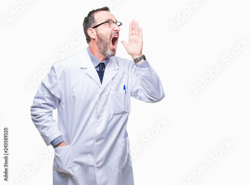 Middle age senior hoary professional man wearing white coat over isolated background shouting and screaming loud to side with hand on mouth. Communication concept.