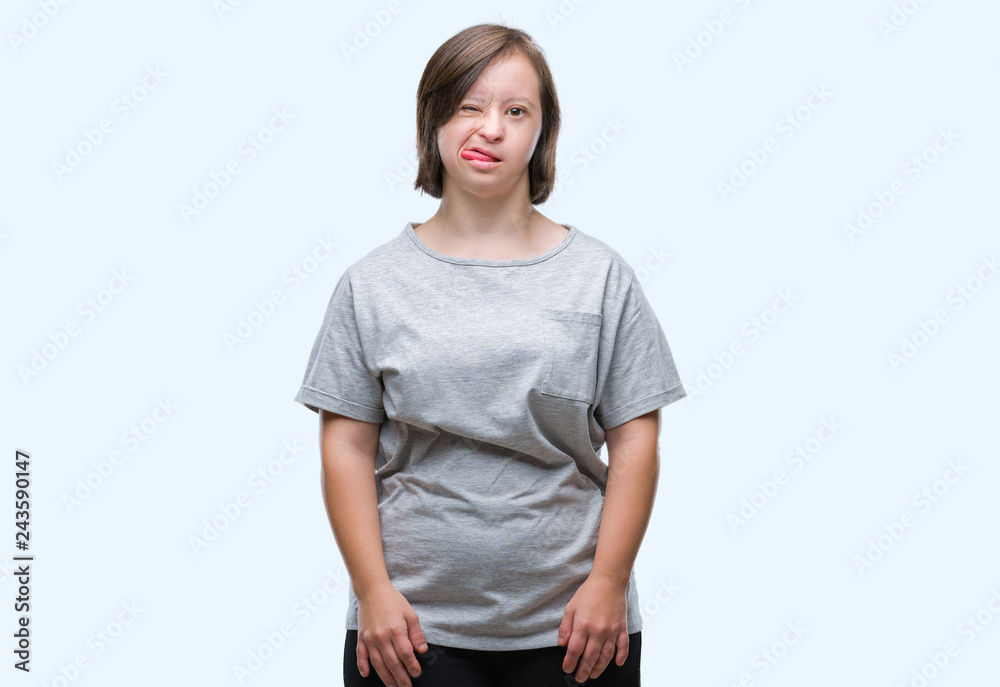 Young adult woman with down syndrome over isolated background sticking tongue out happy with funny expression. Emotion concept. Young adult woman with down syndrome over isolated background sticking tongue out happy with funny expression. Emotion concept.