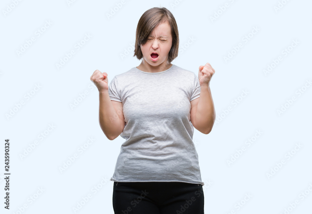 Young adult woman with down syndrome over isolated background celebrating mad and crazy for success with arms raised and closed eyes screaming excited. Winner concept Young adult woman with down syndrome over isolated background celebrating mad and crazy for success with arms raised and closed eyes screaming excited. Winner concept