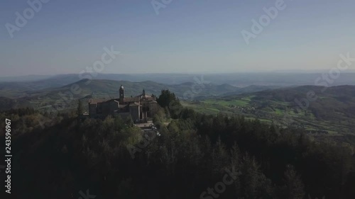 Pull away aerial view across Monte Senario monastery near Florence, Tuscany, in central Italy with vast open green landscape rolling hills. photo