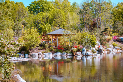 Landscape shot of a gazebo along the pond in the japanese garden at the Frederik Meijer Gardens in Grand Rapids Michigan photo
