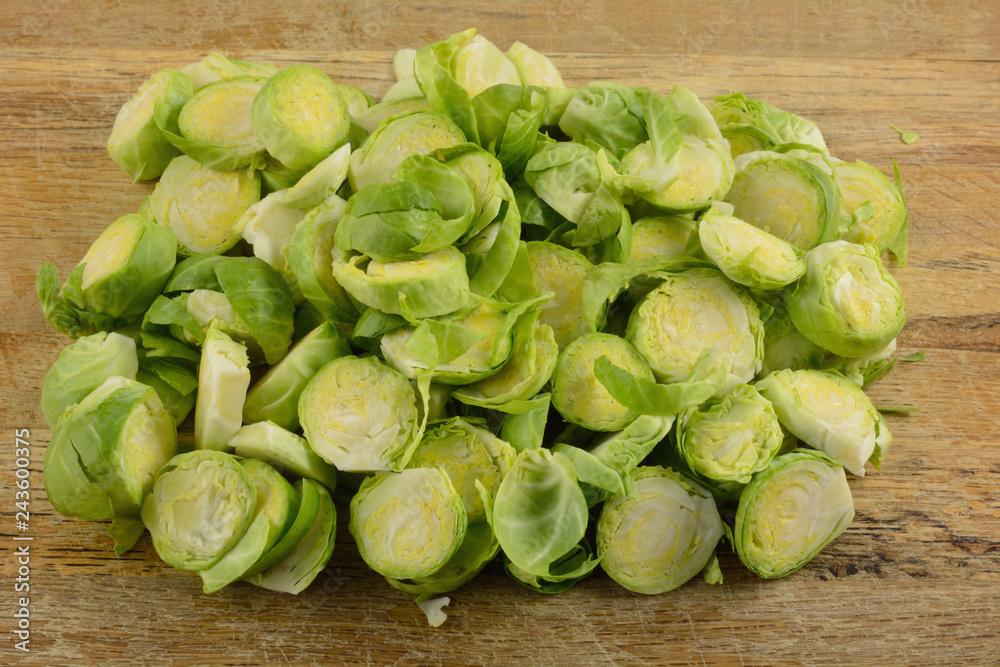 Close up of sliced fresh raw brussel sprouts on rustic cutting board Close up of sliced fresh raw brussel sprouts on rustic cutting board