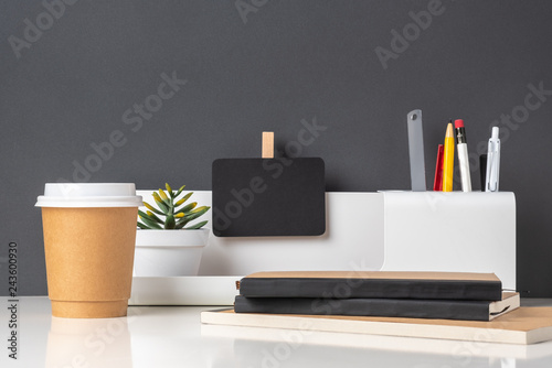 Fototapeta modern office stationery on white table and dark grey wall