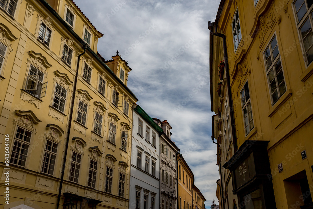 PRAGUE, CZECH REPUBLIC - AUGUST 27, 2015: Light falls in a scenery way upon the beautiful windows of old architecture street in Prague in overcast summer day in the old center of the Czech capital