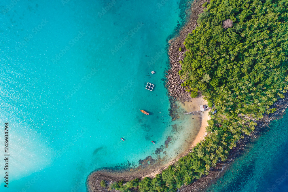 Fototapeta premium Aerial view of exotic turquoise sea with white beach green tree island