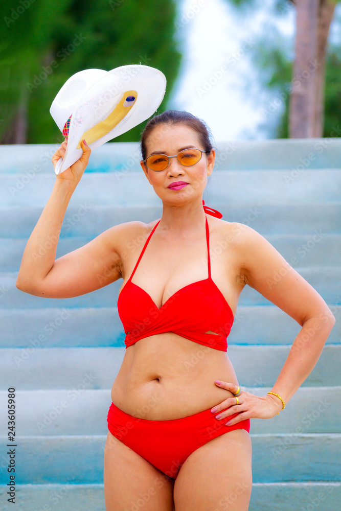 Woman shape with red bikini and hat on beach Stock Photo | Adobe