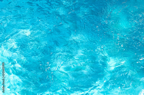 Swimming pool with sunny reflections background. Abstract water surface.
