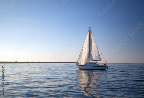 Sailboat reflecting in water when leaving Channel Islands harbor in Oxnard California United States