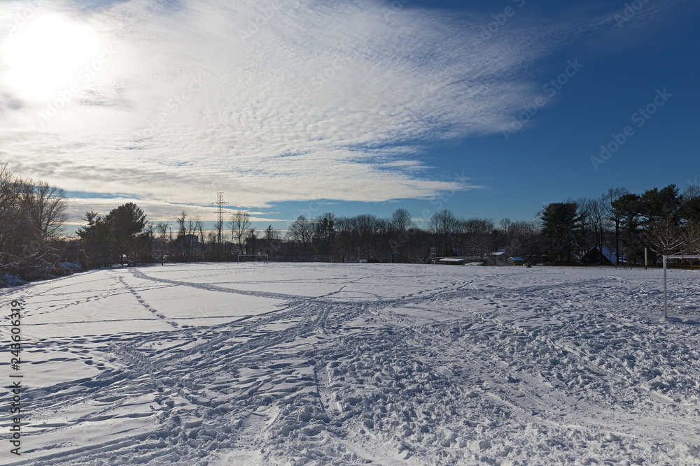 Soccer field in winter after the snowstorm past. Winter activity on the soccer field covered by snow.