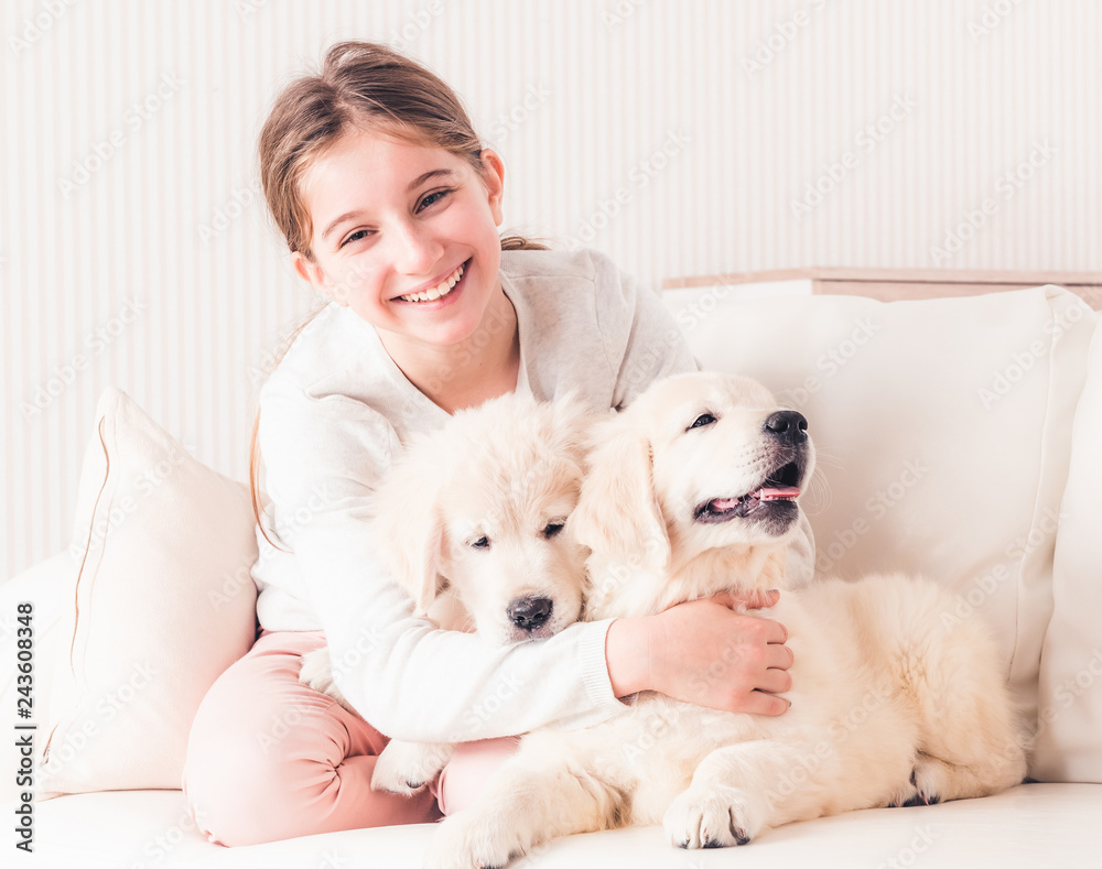 Smiling girl hugging puppies Smiling girl hugging puppies