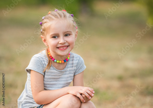 smiling little girl in a summer park