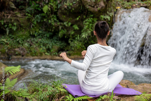 Beautiful girls are playing yoga at the park. Among the natural waterfalls in the forest  exercise concepts