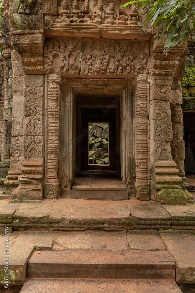 Fallen rocks seen through stone temple doorway