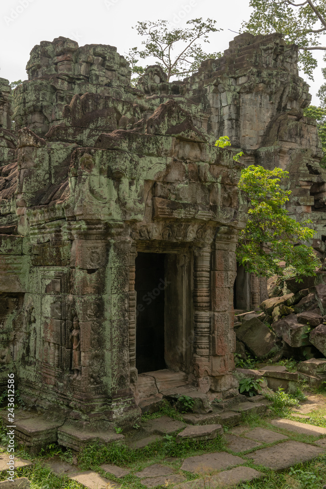 Ruined stone temple portico covered in lichen