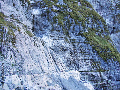 The rocks and stones of the Glarnisch and Vorder Glarnisch mountains above Lake Klontalersee - Canton of Glarus, Switzerland photo